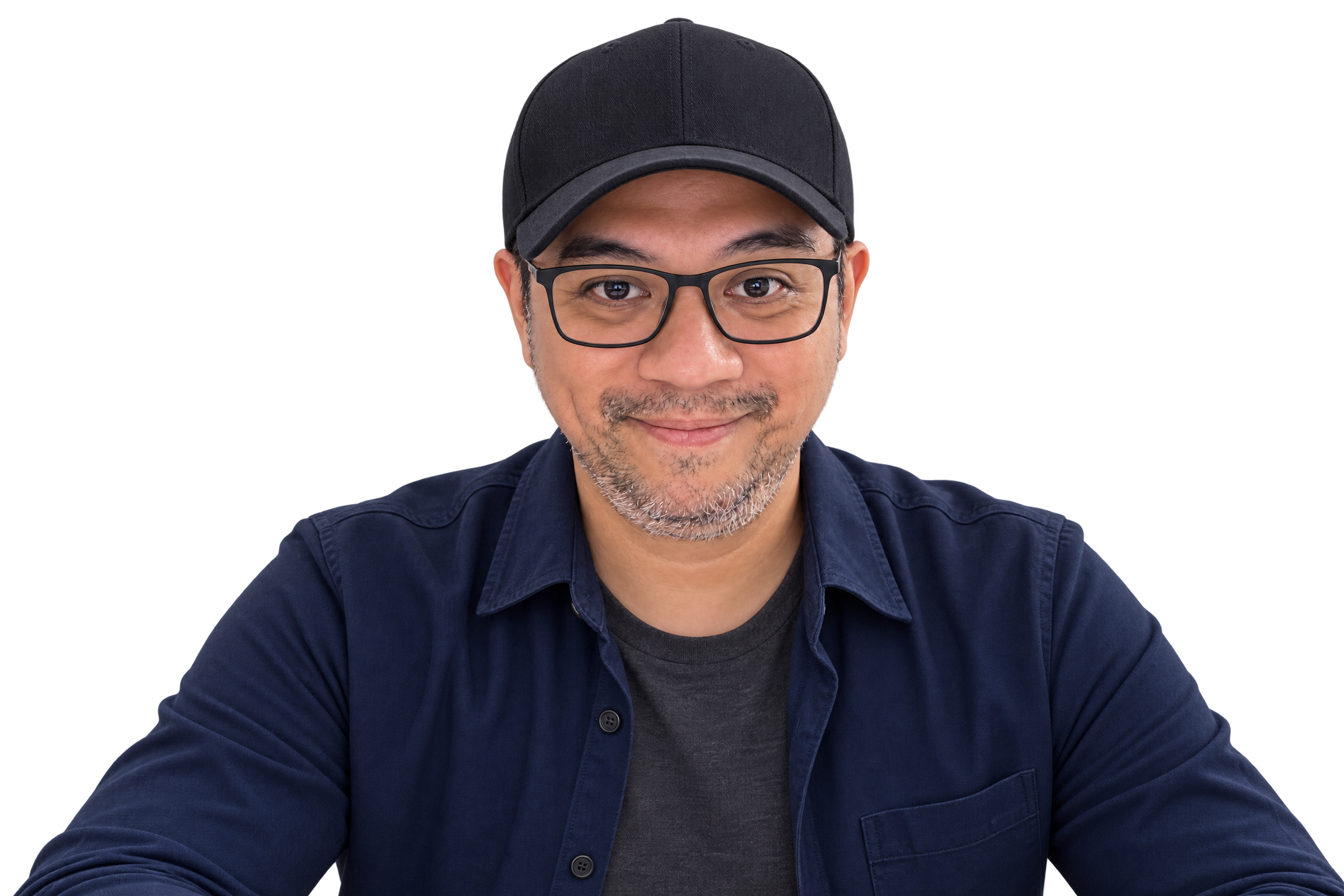 Dan, website builder and funnel designer, wearing a black cap, clear glasses, and a navy overshirt